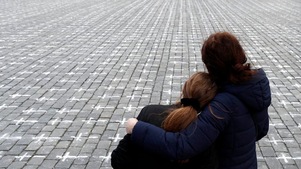 Thousands of crosses painted onto Czech square to protest COVID deaths