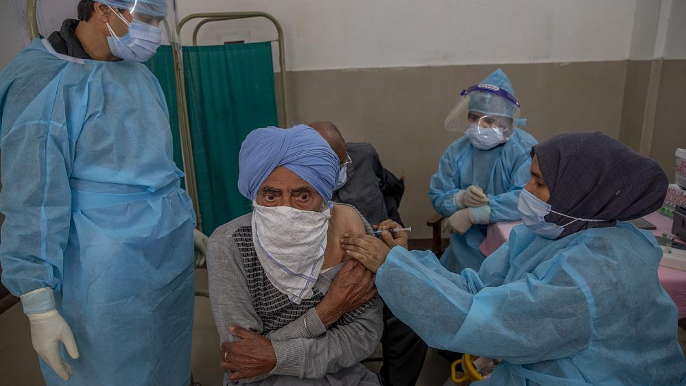 India sets another global record for daily new virus cases and looks to bolster vaccine rollout