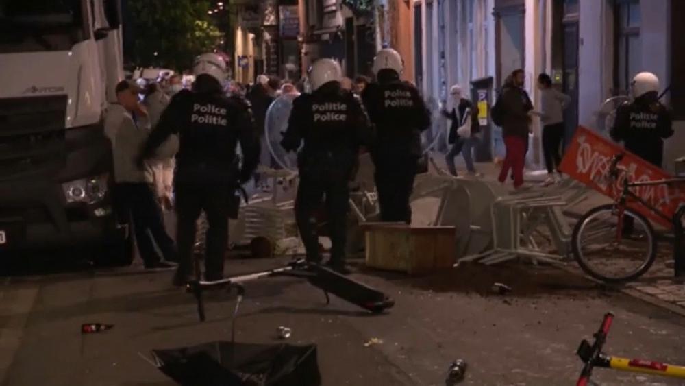 Police in Brussels break up crowds of people celebrating the end of curfew